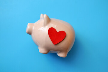 The heart is in the piggy bank. A symbol of protection and preservation of love