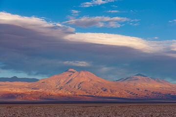 Sunset over landscape with volcanoes and sal-flat in the north of Chile
