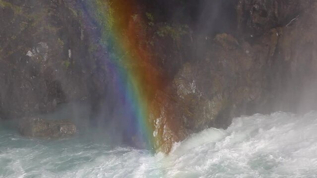 The raging fast flowing river with rainbow after the Salto Grande waterfall in Torres del Paine National Park, Chile