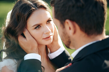 Lovely woman looking on man. Stylish stunning couple together on their wedding day