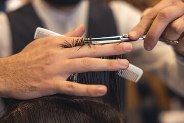 Close up of hairdressers hands cutting hair