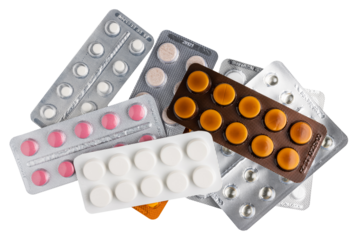 Various pills and tablets in a blister packs isolated on transparent background, top view, healthcare and medicine concept