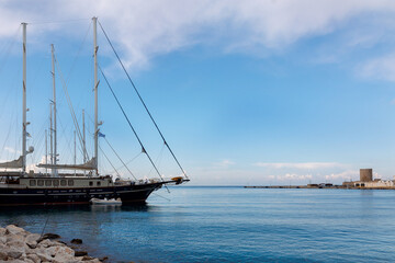 Fototapeta na wymiar Panoramic view of beautiful yachts stand in harbor in port of Rhodes, Greece. High quality photo