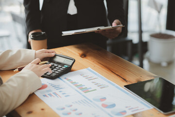 The sales department is having a monthly summary meeting to bring it to the department manager, they are verifying the correctness of the documents that are prepared before bringing in to the manager