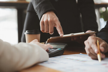 The sales department is having a monthly summary meeting to bring it to the department manager, they are verifying the correctness of the documents that are prepared before bringing in to the manager