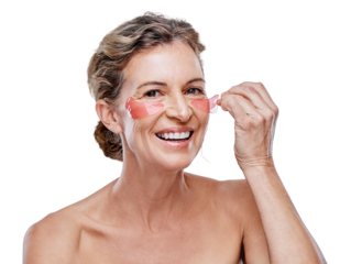 A mature woman wearing under-eye gel patches while posing against isolated on a transparent PNG background