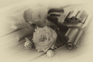 vintage still life with gun and rose in black and white