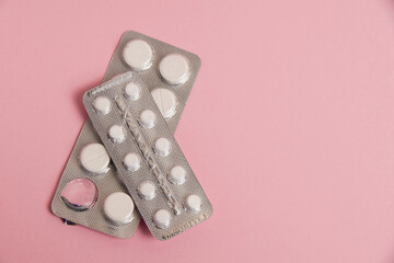 Opened blisters with pills on a pink background. Concept of treatment of chronic diseases