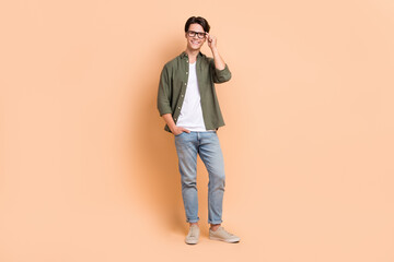 Full body length size cadre of young optimistic man wear stylish outfit casual style new eyeglasses advertisement isolated on beige color background - Powered by Adobe