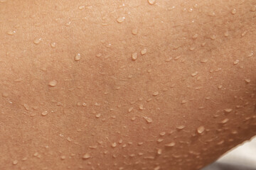 Closeup of wet tanned female skin