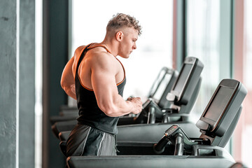 Fototapeta na wymiar athlete on a treadmill in the gym