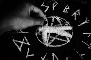 magic doll and White occult symbol on the witchcraft blackboard photo
