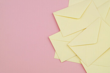 Many mail envelopes on pink background. Copy space for text.