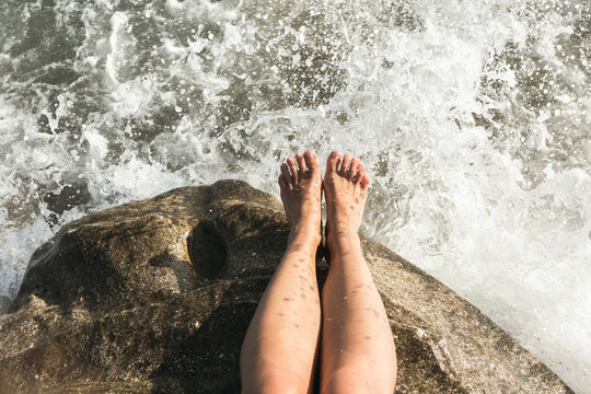 Female feet over stormy sea with first person view
