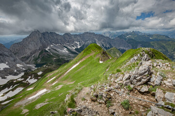 Between Italy and Austria: on the top of mountain near Volaia Lake Raunchkofer Mountain (Lago di Volaia Monte). Mountain hiking Trail Road.