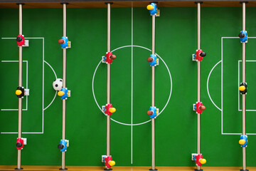 Top view of a table football game in progress
