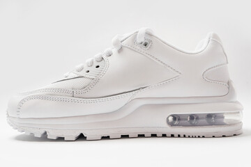 Leather trainers with a shadow on white background