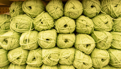 Fototapeta na wymiar Knitting background, a lot of balls. Knitting yarn for handmade winter clothes, green wool