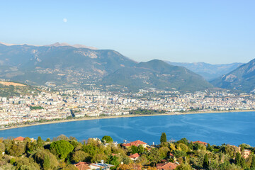 Beautiful panorama of Alanya (Turkey) with the moon on the blue sky. View from the fortress of Alanya (Alanya Kalesi)
