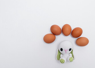 easter concept. Knitted Easter bunny or rabbit with eggs on white background. photo. copy space