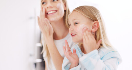 Skincare, mother and daughter home spa day washing their face in bathroom or apply beauty product,...