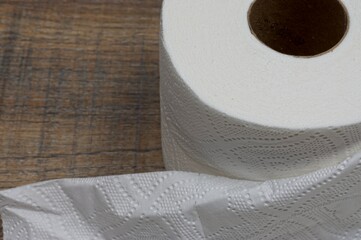 Toilet paper roll on a wooden plank background