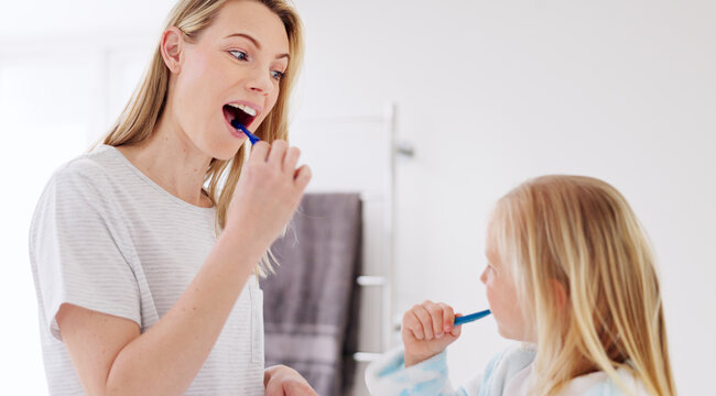 Toothbrush, Mother And Girl Cleaning Their Teeth In The Morning In The Bathroom Of Their Family Home. Happy, Bond And Mom Doing A Dental Hygiene Routine For Health With Oral Products With Her Child.