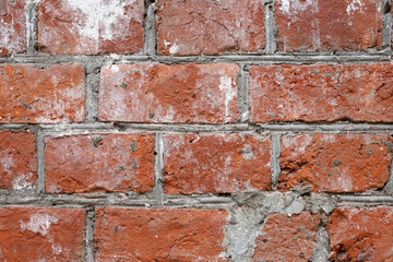Fototapeta premium Red brick wall texture. Old facade of a building with concrete joints, vintage background