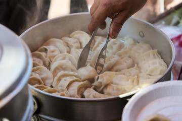 Vegetarian traditional dumpling momos. Tibetan momo Street food in Mall road Kullu Manali Himachal...