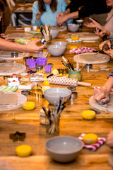Ceramic workshop. Women working on the table in the workshop with various tools and molds.
