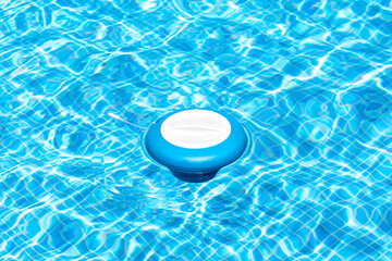 Floating pool skimmer adding chlorine to the water for disinfection and prevention against the...