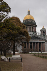 St. Isaac's Cathedral in St. Petersburg, the square in front of it with trees, benches, people. Late fall.