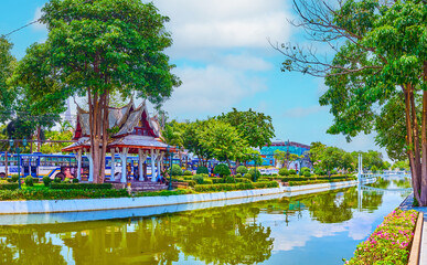 Shady park on banks of Rop Krung canal in Bangkok, Thailand