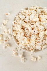 bowl with popcorn on a marble table, top view, selected focus.