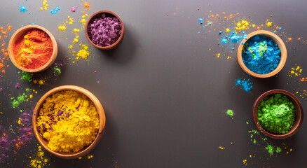 Happy Holi decoration, the indian festival.Top view of colorful holi powder on dark background.