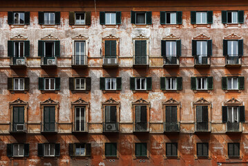 Architecture of Rome, Italy. The facade of an old building with wooden  windows shutters.