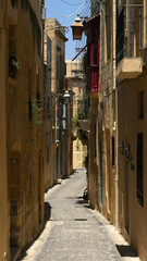 Fototapeta na wymiar A typical narrow street in the city of Victoria, the capital of Gozo