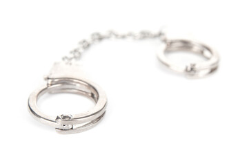 Metal handcuffs on a white background