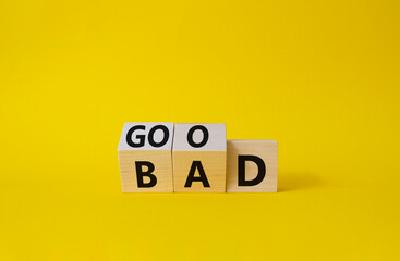 Good vs Bad symbol. Wooden cubes with words Bad and Good. Beautiful yellow background. Business and Good vs Bad concept. Copy space