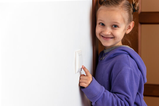 Turn off the Lights, Saving Energy and Reducing Energy Consumption of the World. Kid Girl Switching off Light. Copy Space.