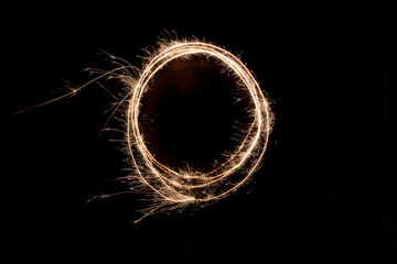 Different figures, letters or drawings created at night with flares; infinity symbol, a heart, cross or different letters