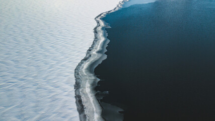 Half frozen lake in the winter, background 