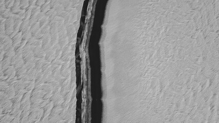 black and white texture, snow and water above