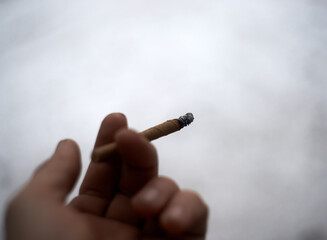 Holding cigarette in my hand.