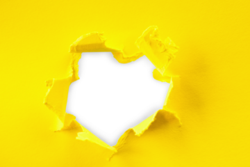 yellow and white Hole in the paper with torn sides.