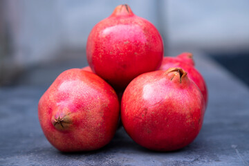 Fototapeta na wymiar Ripe pomegranates on a dark background. Selective focus