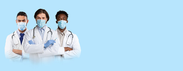 Men in medical face masks doctors posing on blue