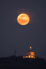 San Luca churc under a big orange full moon