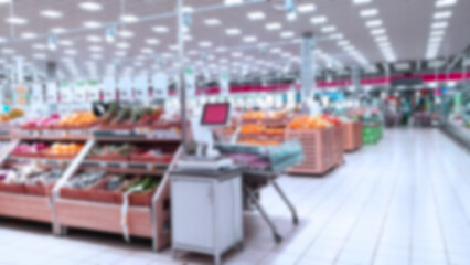 Abstract blur image of supermarket background. Defocused shelves with fruits, vegetables. Grocery store. Retail industry. Discount. Inflation and recession concept. Aisle. Consumer packaged goods. CPG