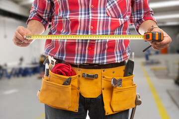 Close-up of worker man holding yellow ruler